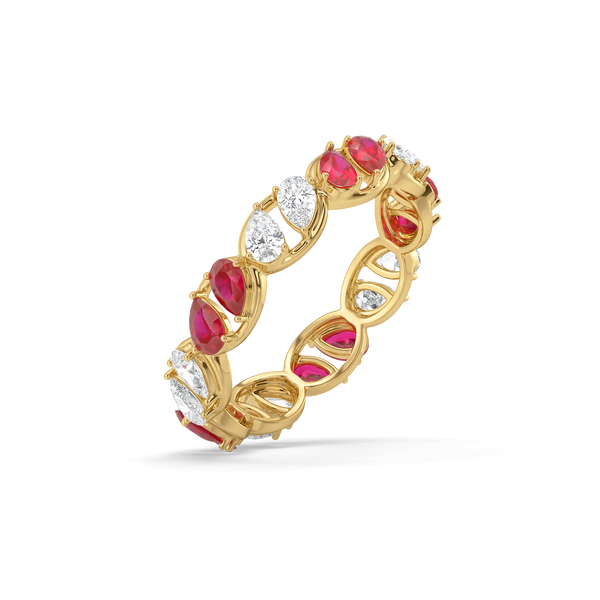 Gold ring with red gemstones and diamonds on a white background
